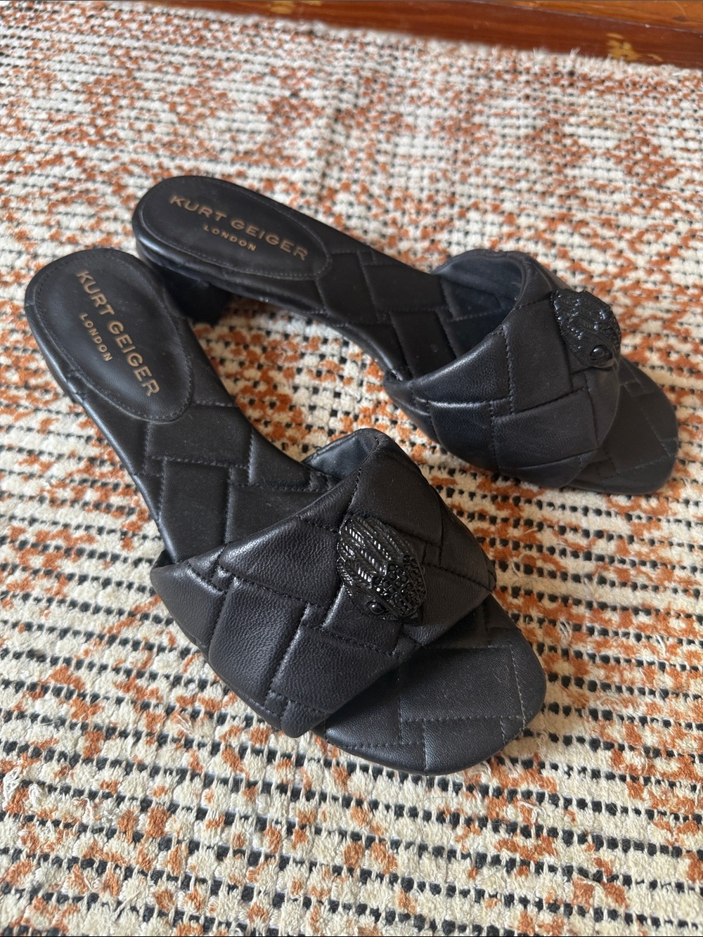 Kurt Geiger Black Quilted Slide Mules with Embellished Crest